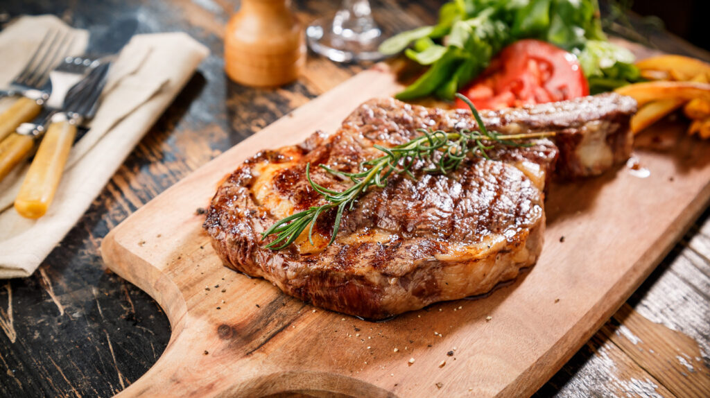 A perfectly grilled steak resting on a cutting board