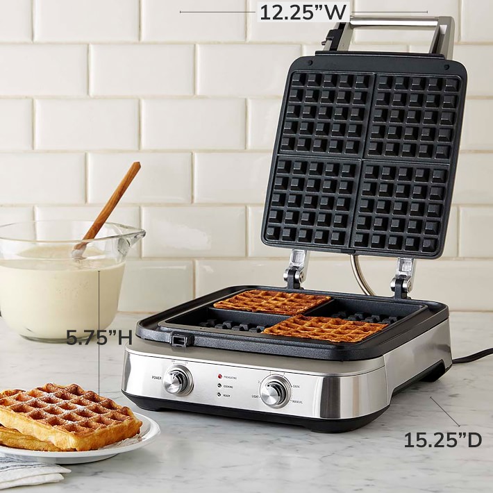 Close-up of a Breville Smart Waffle Pro with a waffle cooking inside, showcasing its digital display with browning control settings.