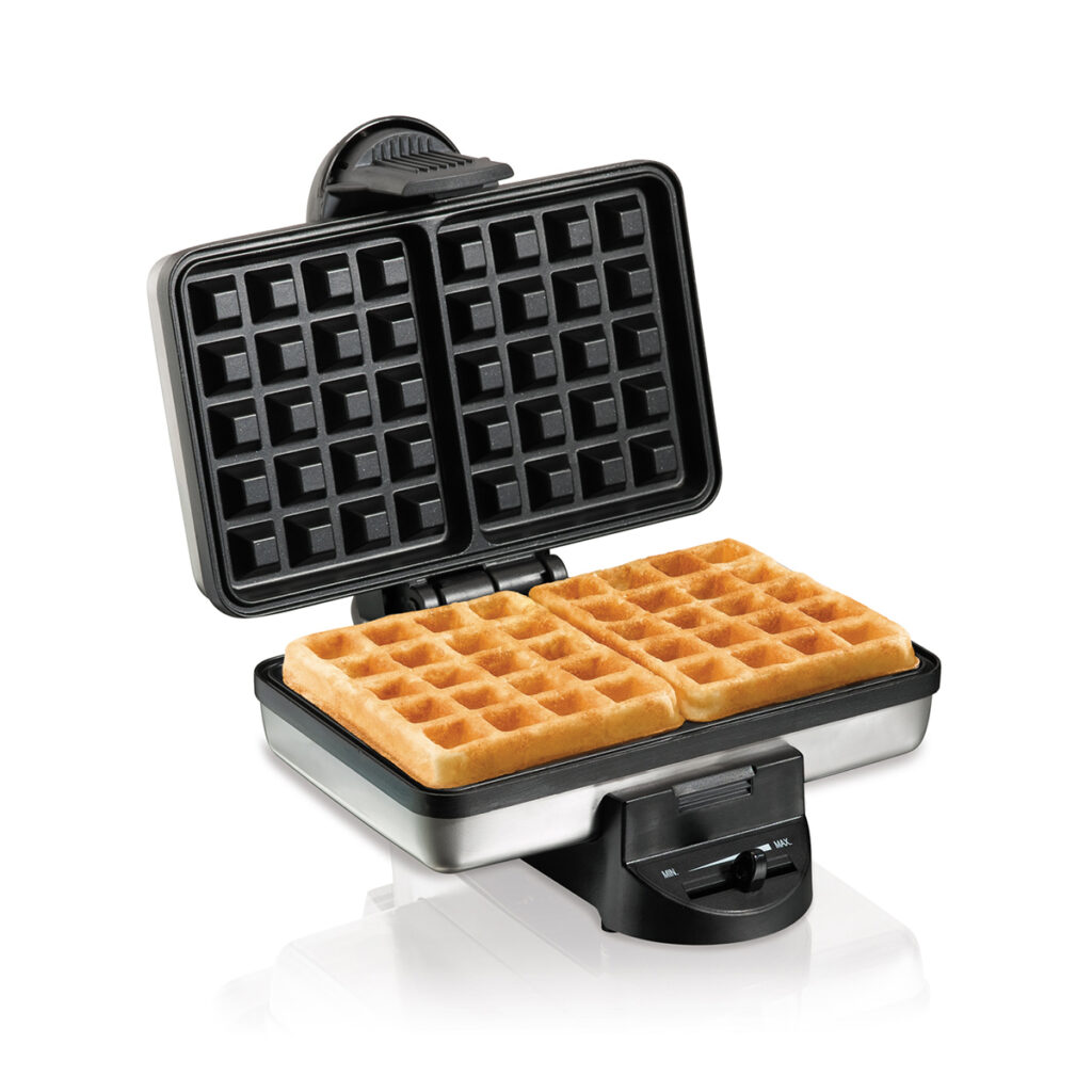 A Hamilton Beach Belgian Waffle Maker on a kitchen counter, with a freshly cooked, golden-brown waffle