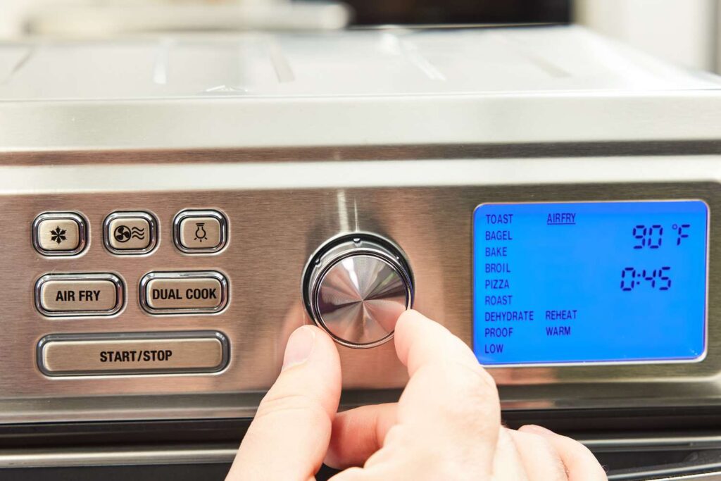 Close-up view of the control panel on the Cuisinart Air Fryer Toaster Oven, showing temperature, function, and timer dials